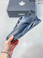 Side view of the black low-top sneaker showing layered panels and the sculpted sole.