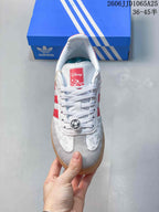Top view showing white laces, a red Disney tongue label, embossed upper graphics, and a soccer-ball lace ornament.