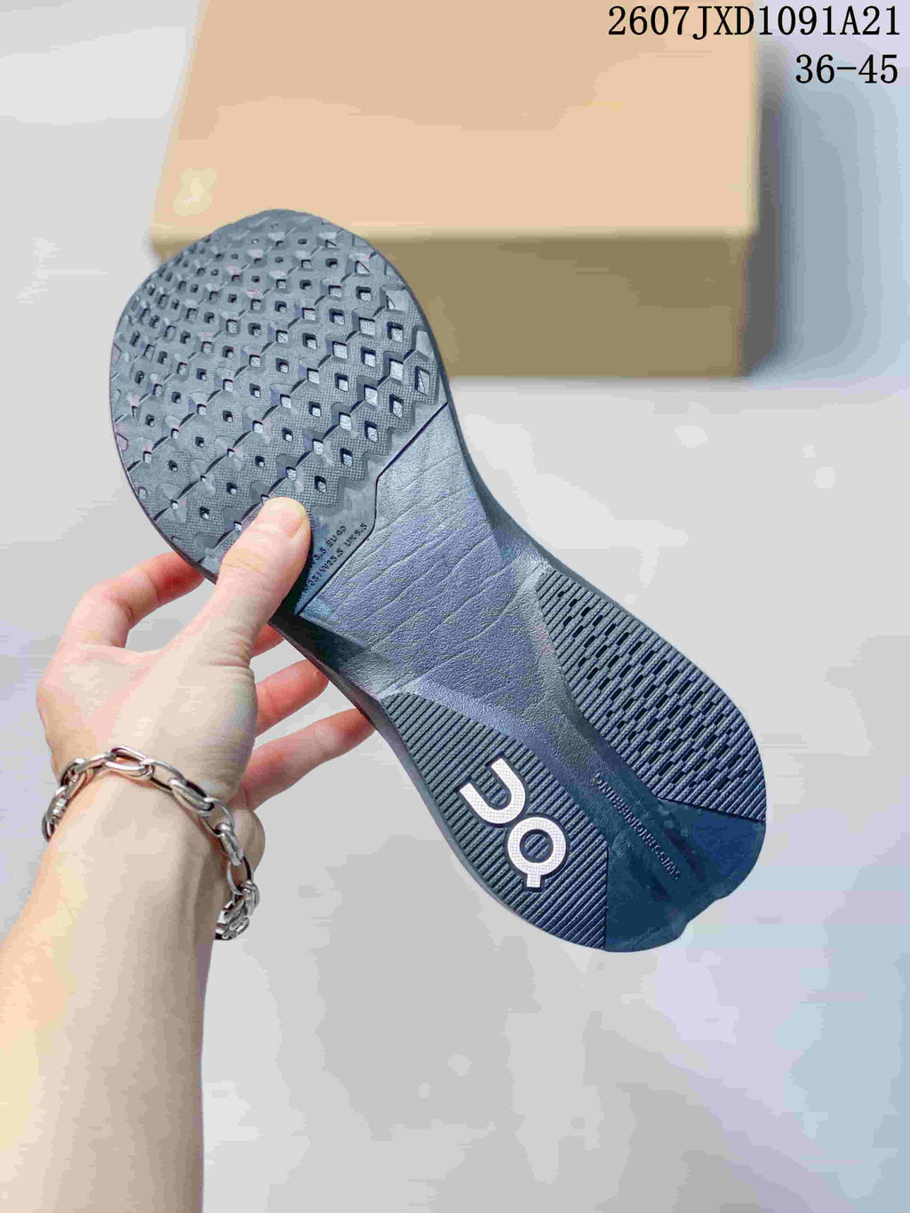 Bottom view of the sneaker showing the dark patterned outsole and traction sections.