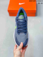 Top view of a Nike Zoom Winflo 8 shoe showing the navy laces, textured gray upper, navy toe panel, and lime green interior.