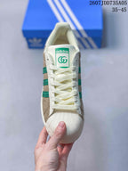 Top view showing the cream laces, Adidas tongue label, green emblem, and textured shell toe.