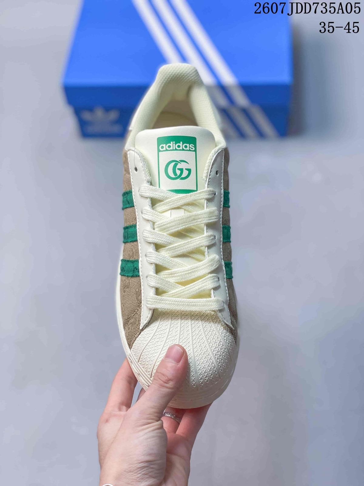 Top view showing the cream laces, Adidas tongue label, green emblem, and textured shell toe.