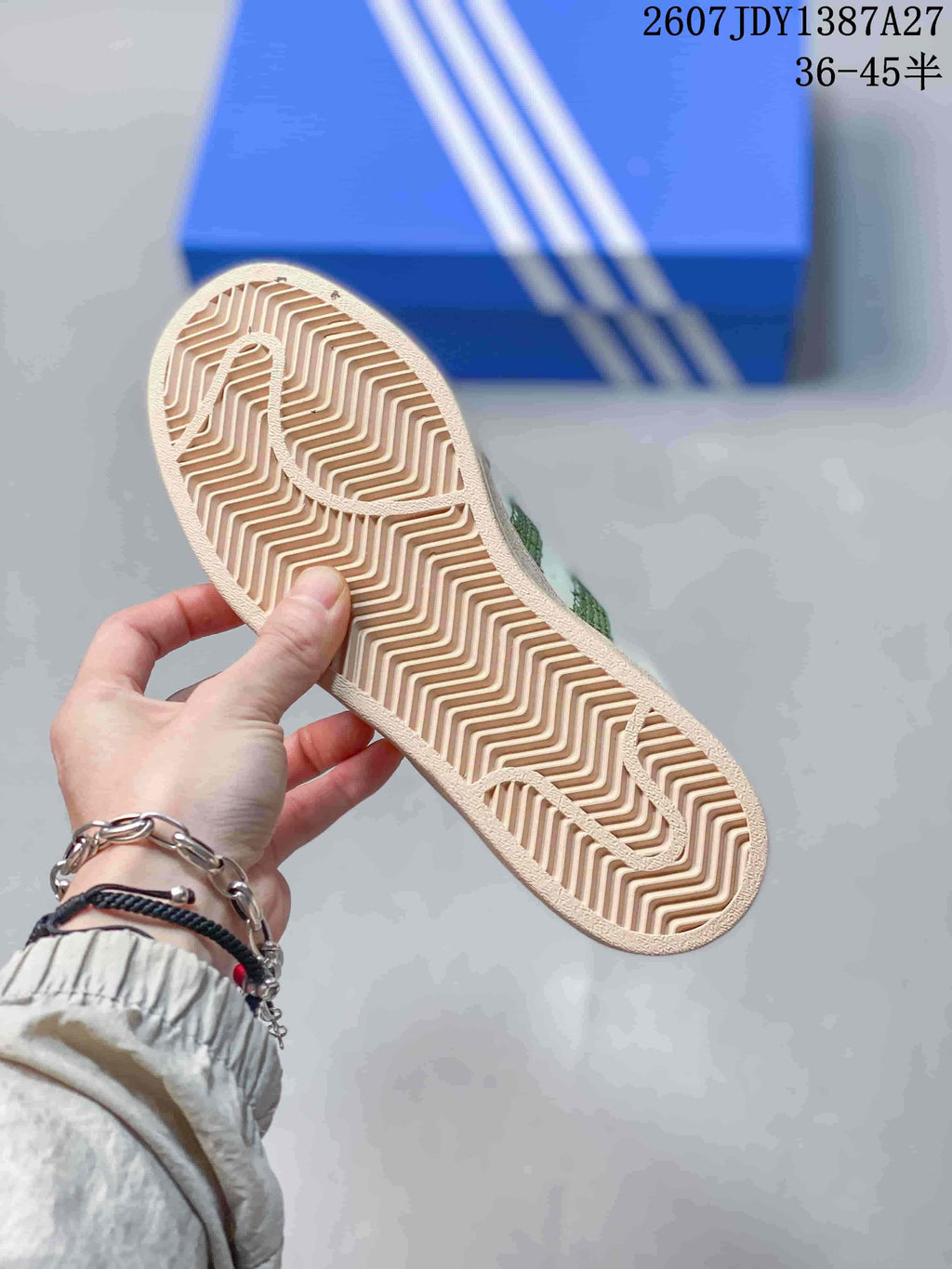Close view of the beige rubber outsole showing its zigzag tread pattern.