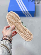 Close view of the beige rubber outsole showing its zigzag tread pattern.