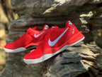 Angled view of a pair of red Nike Kobe 8 shoes with white side logos