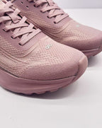 Close-up of the textured pink toe box, woven laces, and alo branding.