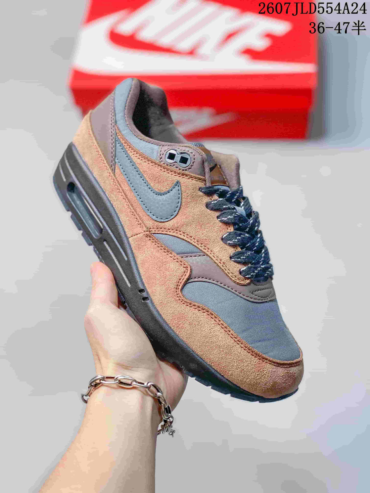 Angled side view of the brown and grey Nike Air Max 1 sneaker with a visible Air Max midsole window.