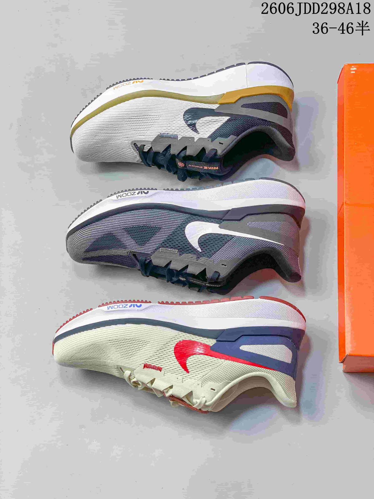 Three Nike running shoes shown from the side in dark gray, light gray, and light colorways.