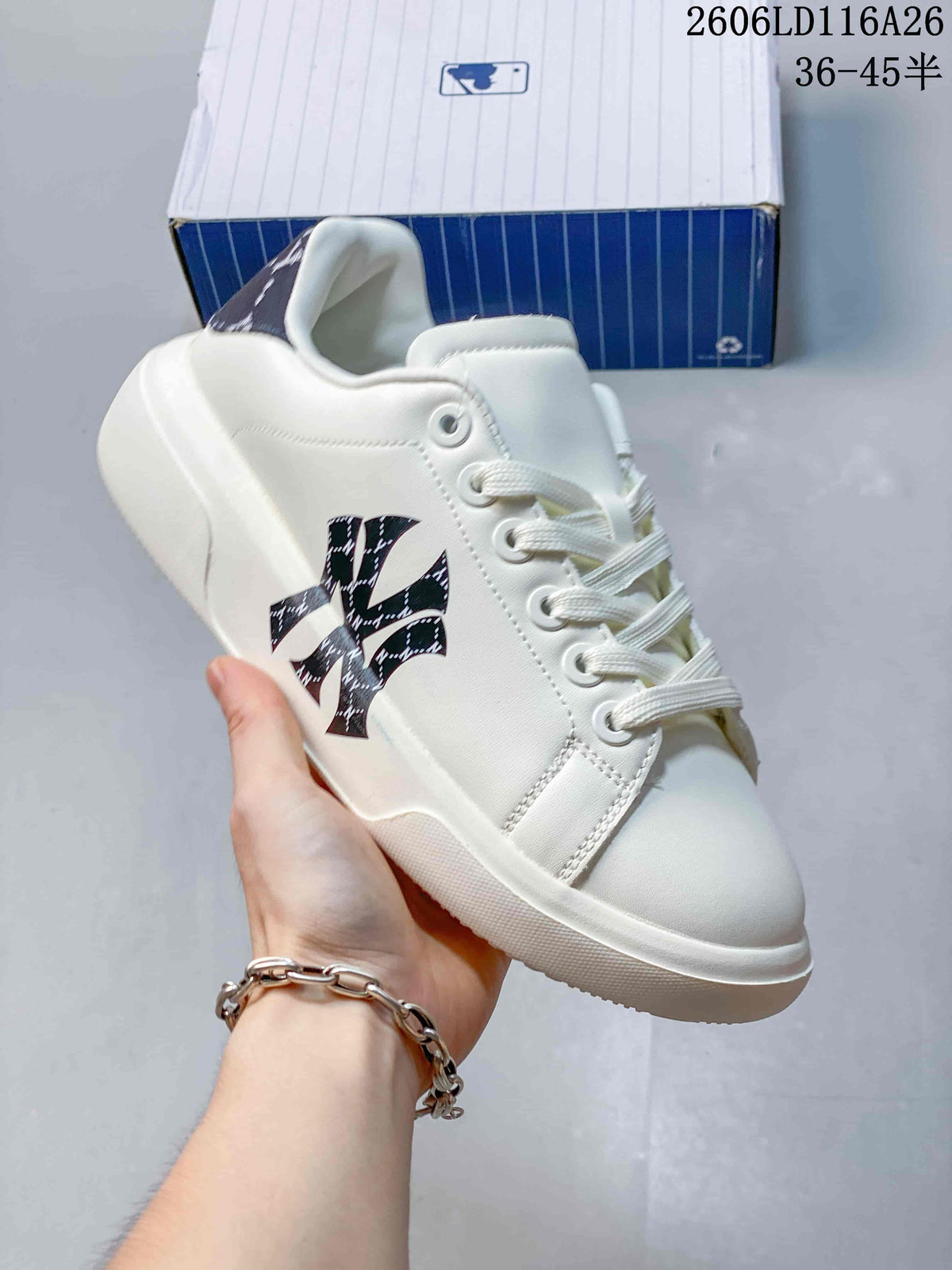 Close-up of a white low-top sneaker with a patterned MLB side monogram