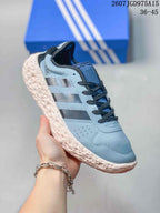 Angled side view of the light blue lace-up sneaker with black stripes and a textured cream-colored sole.