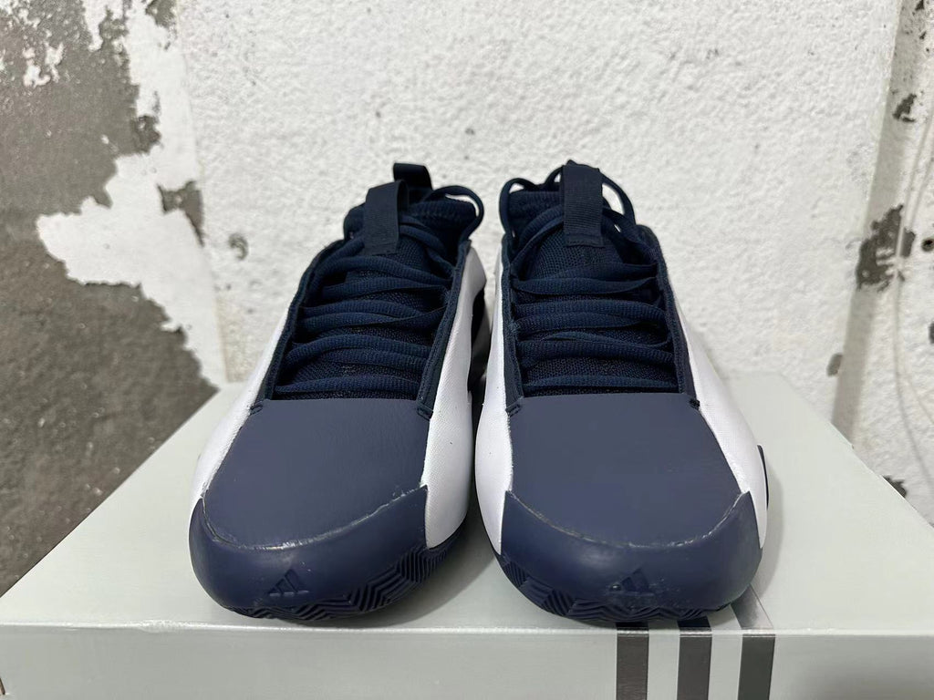 Front view of navy and white Adidas basketball shoes with lace-up uppers.