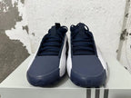 Front view of navy and white Adidas basketball shoes with lace-up uppers.