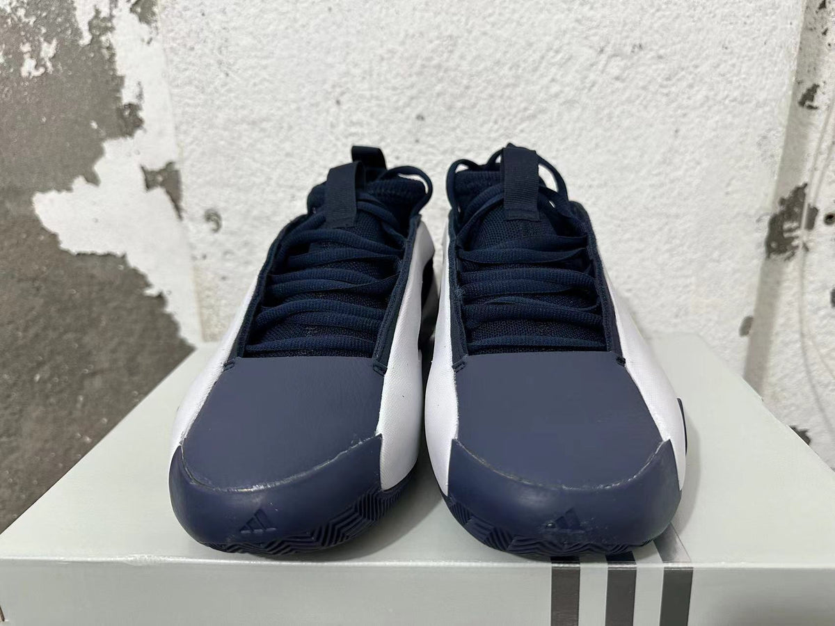 Front view of navy and white Adidas basketball shoes with lace-up uppers.
