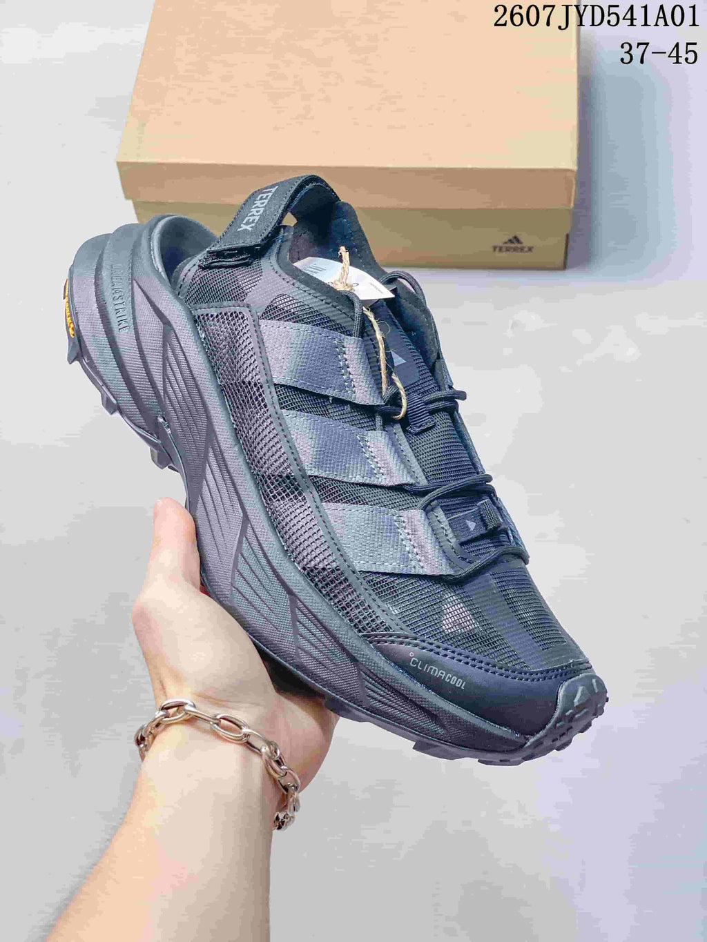 Angled side view of a dark gray Terrex outdoor shoe