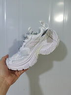 White sneaker shown from the opposite side with lace-up construction, padded collar, mesh details, and textured outsole.