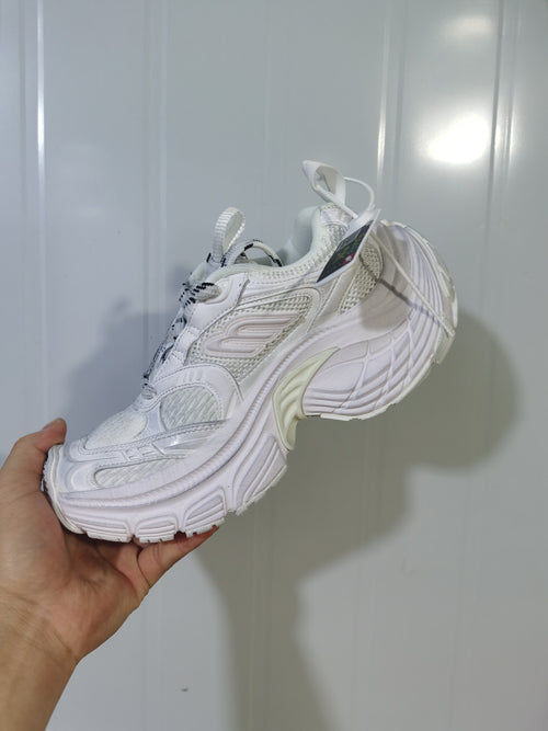White sneaker shown from the opposite side with lace-up construction, padded collar, mesh details, and textured outsole.