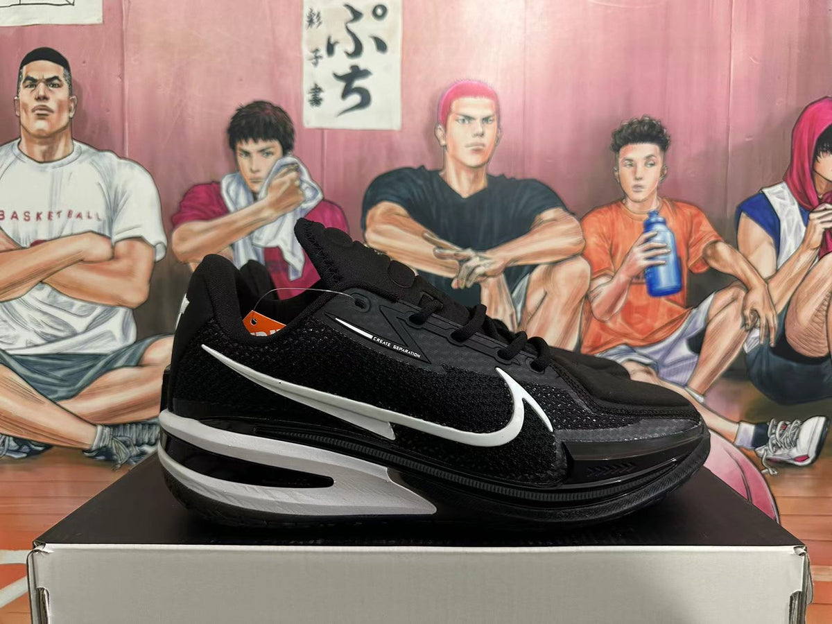 Side view of a black basketball shoe with white accents and a Swoosh-style mark