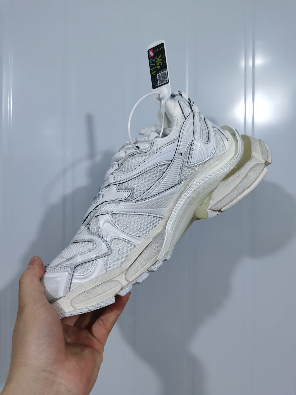 White PUMA sneaker shown from the outer side, highlighting layered panels, textured mesh, and the sculpted sole.
