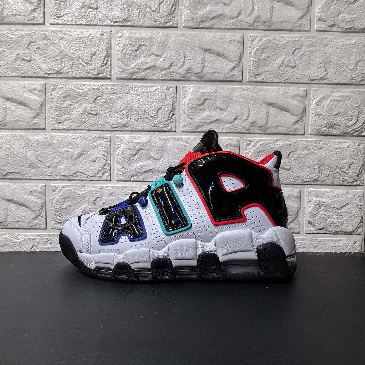 Opposite side view showing oversized AIR lettering on the white and black sneaker