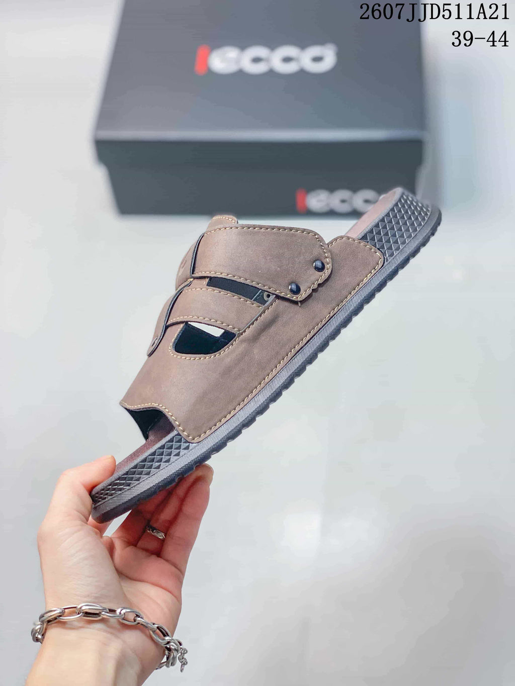 Side view of the brown sandal showing the layered adjustable straps, open toe, and textured sole.