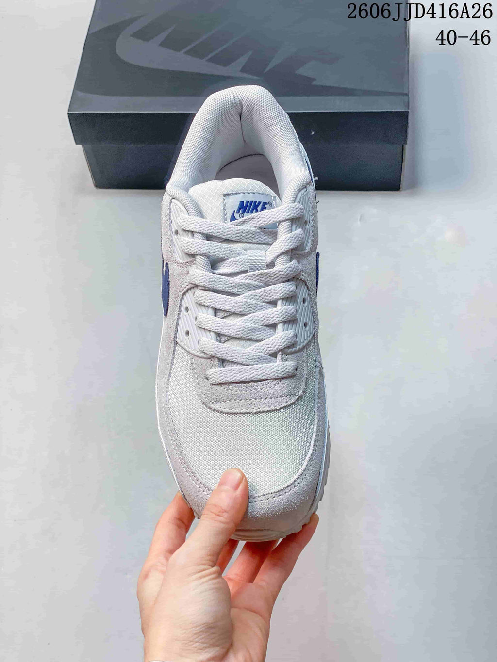 Top view of the white sneaker showing the mesh-style toe area, laces, and padded collar.