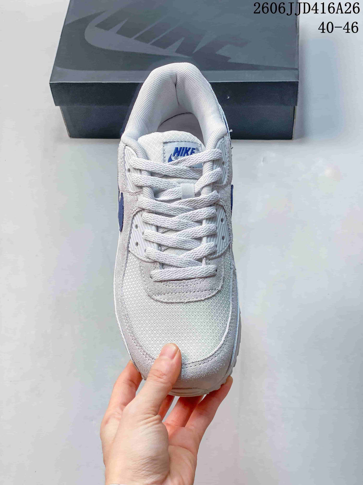 Top view of the white sneaker showing the mesh-style toe area, laces, and padded collar.
