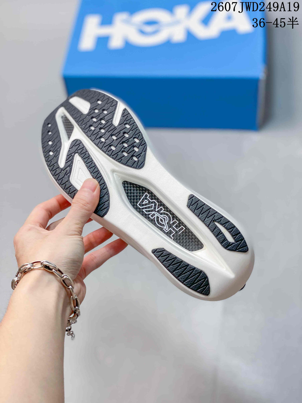 Close view of the patterned outsole with dark traction sections and a white midsole.