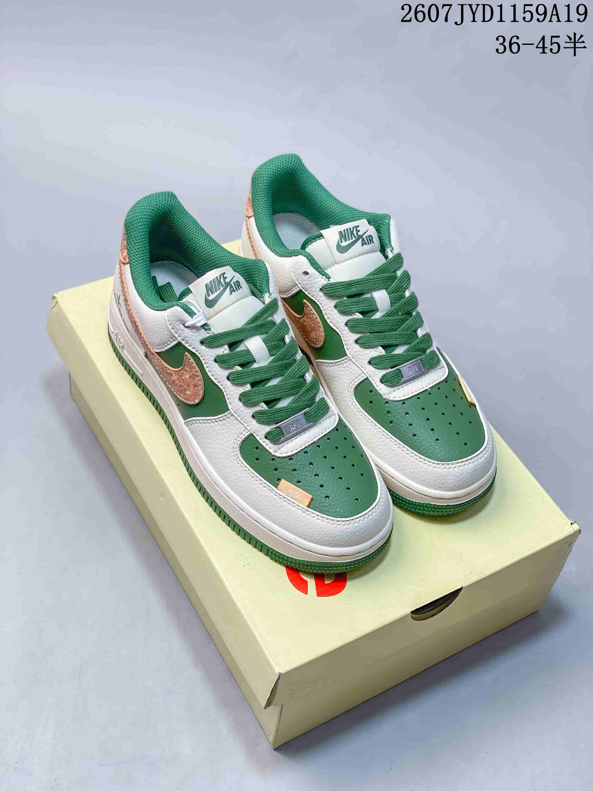 Pair of white and green low-top sneakers with contrasting textured copper-colored side overlays and green padded collars.