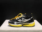 Opposite side profile showing the black upper, white arrow graphics, yellow sole, and attached hangtag.