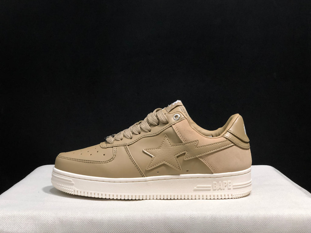 Side profile of a beige BAPE STA sneaker showing the star-shaped side applique and white sole.