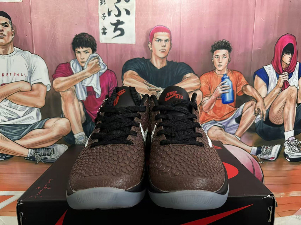 Front view of brown textured Nike basketball shoes with black laces and red Nike Air tongue branding.