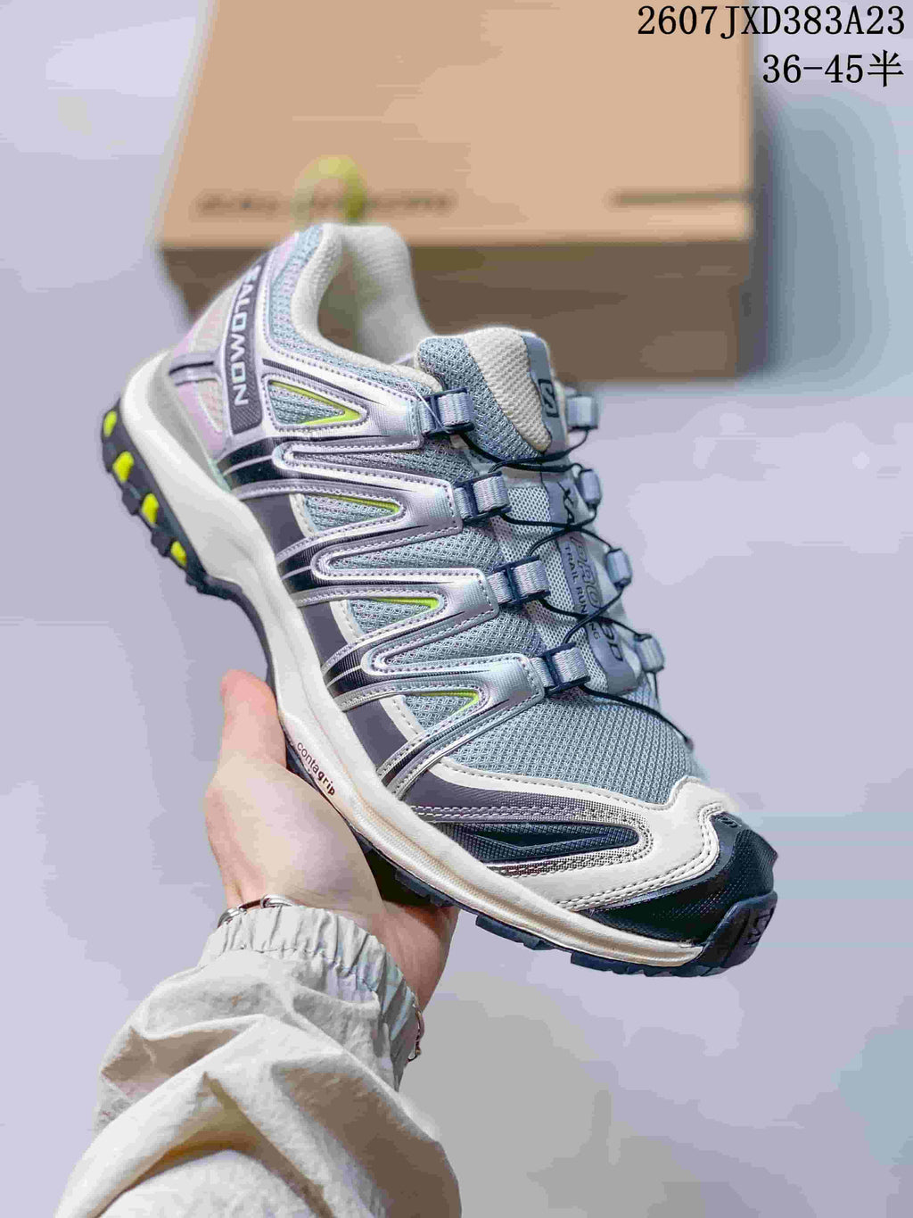 Angled side view showing the Salomon branding, mesh upper, layered side panels, cord fastening, and rugged outsole.