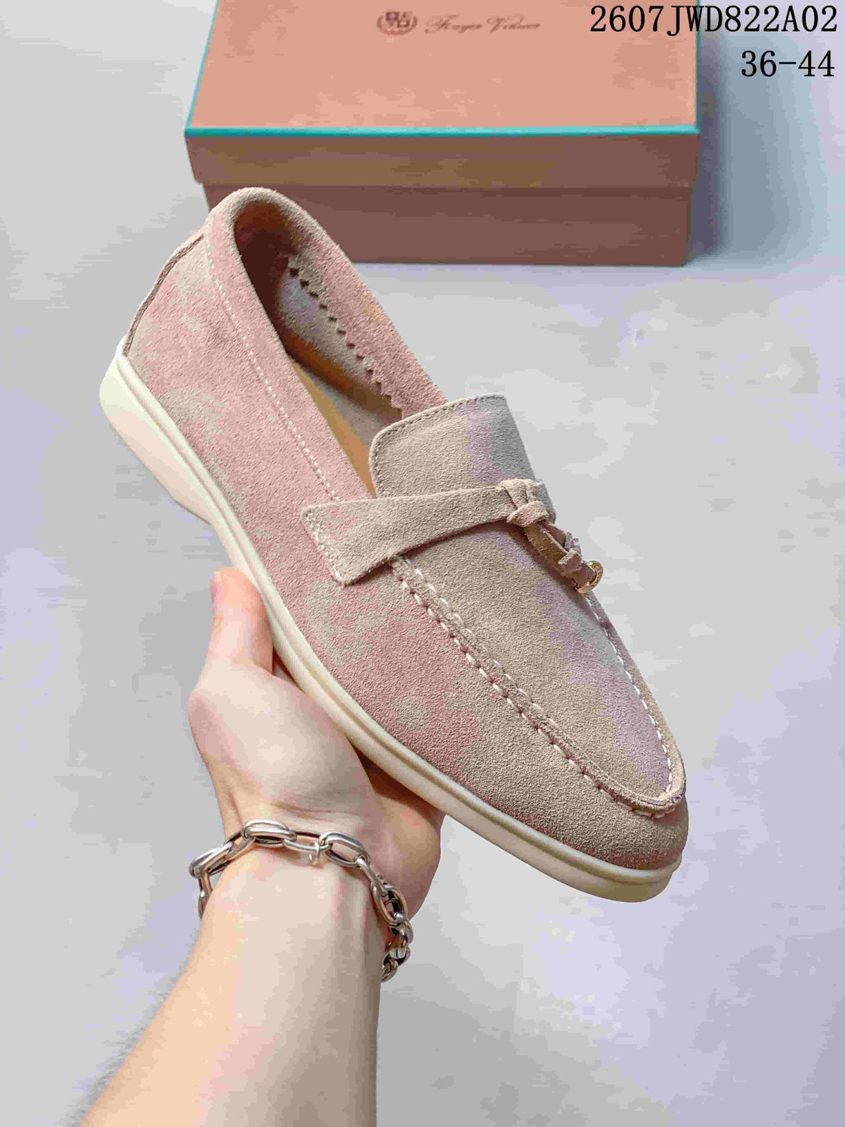 Side view of a pale neutral loafer with a light-colored sole