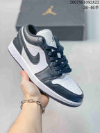 White and black low-top Jordan sneaker with a black Swoosh and dark laces.