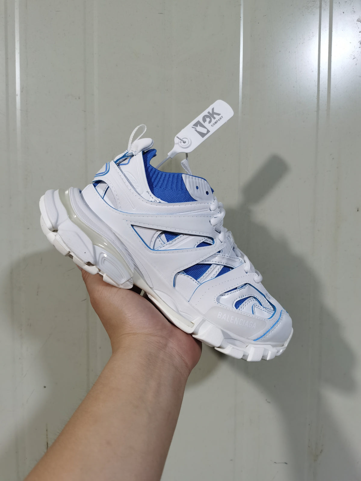 White and blue Balenciaga Track Sock sneaker shown from an angled front view, highlighting the knitted collar, layered upper and chunky sole.
