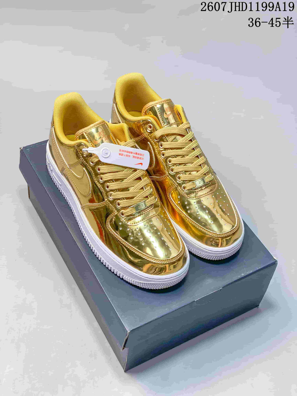 Pair of metallic gold low-top sneakers with perforated toe boxes and white outsoles.