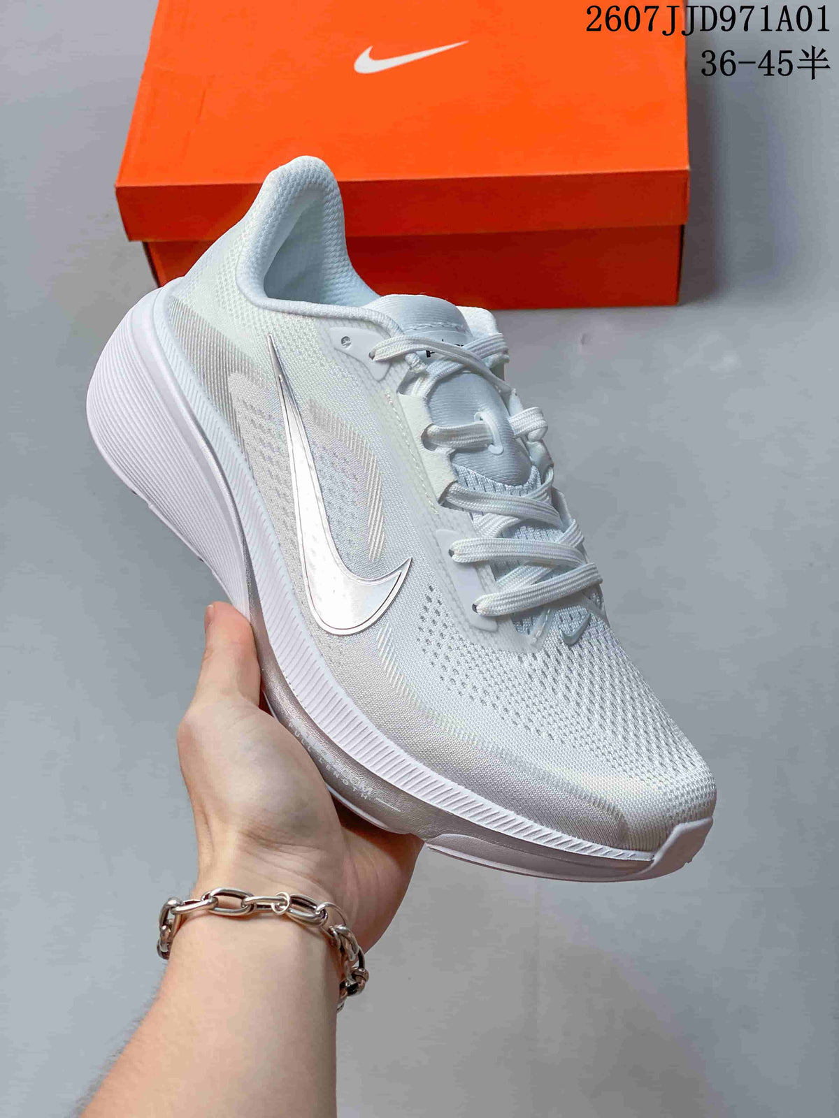 Angled side view of the white running shoe with silver-toned accents