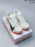 Pair of off-white Nike ACG Ultrafly Trail sneakers with black branding and orange outsoles displayed on a shoe box.
