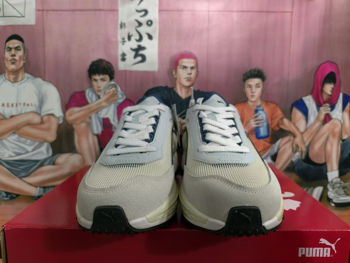 Front view of white and navy PUMA Rider Elite sneakers with lace-up closure