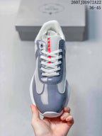 Top view showing the rounded gray toe, white laces, white mesh, and red tongue branding.
