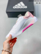 Side view showing the mesh upper, lace-up construction, gray adidas stripes and pink outsole detail.