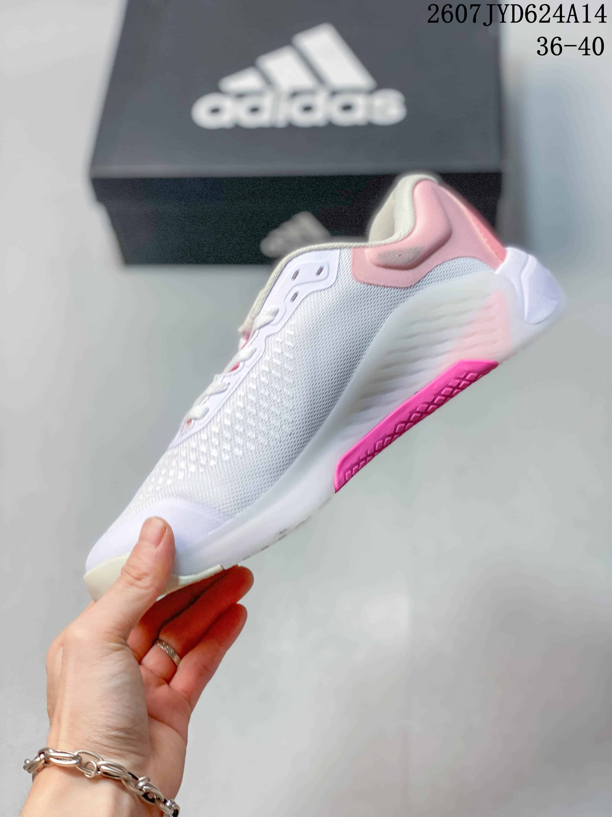 Side view showing the mesh upper, lace-up construction, gray adidas stripes and pink outsole detail.