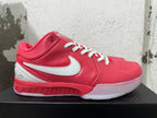 Side view of a pink Nike Kobe basketball shoe with a white Swoosh and translucent-looking sole.