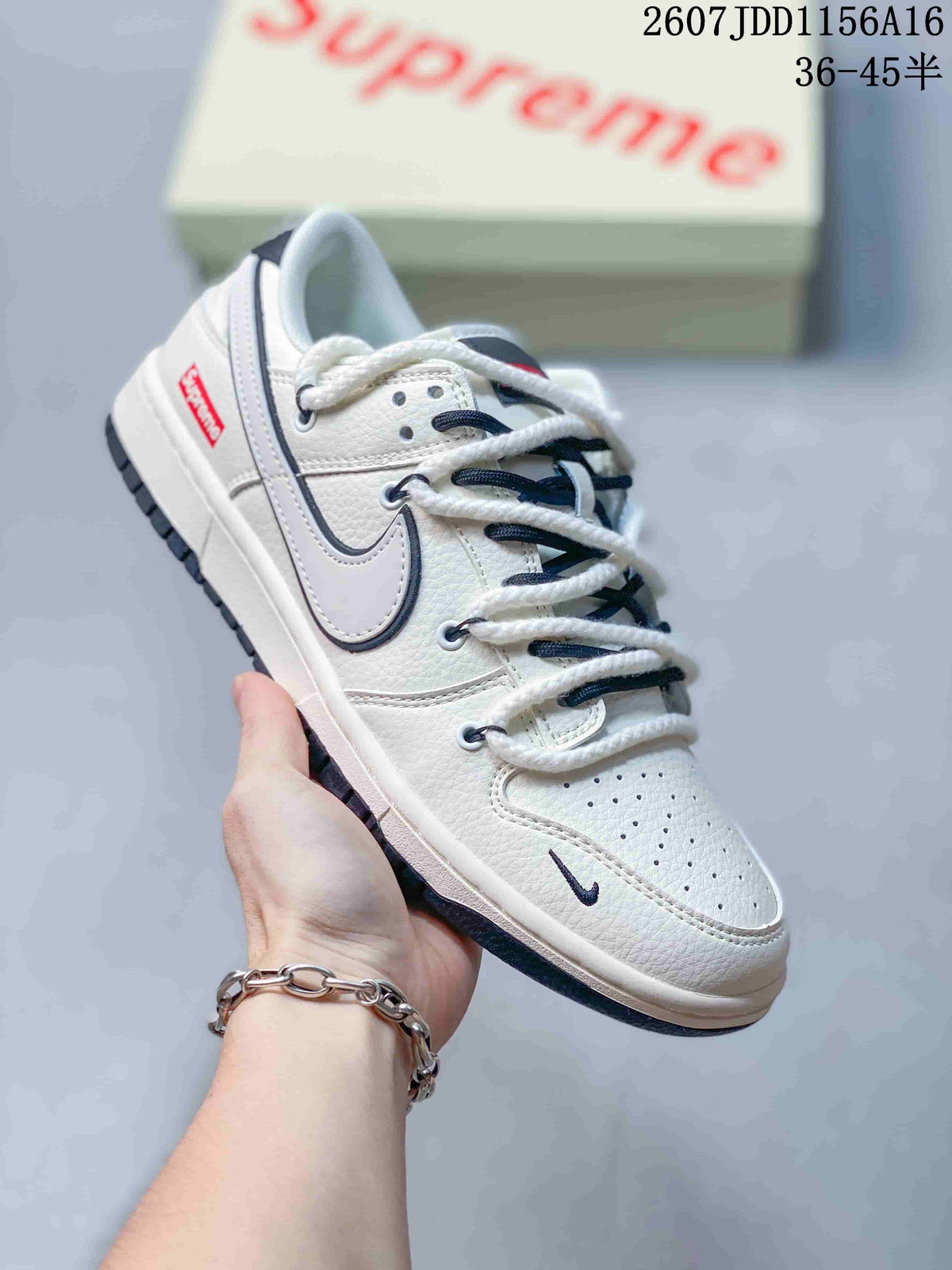 Close side view of an off-white sneaker with layered white and dark laces, a contrasting Swoosh and a red side label.