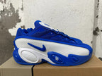 Side view of a blue and white Nike sneaker with a sculpted sole and Kentucky lettering