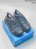 Pair of black and charcoal HOKA Hopara OG sandals displayed on a blue shoebox; image text shows style code 2607JGD977A27 and EU size range 36–45.