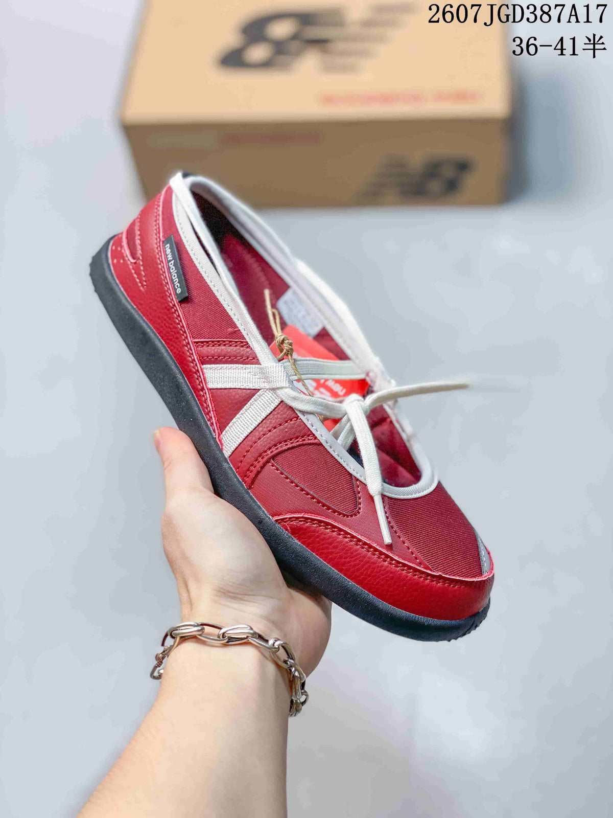 Angled side view of the red New Balance sneaker with white laces and dark outsole.