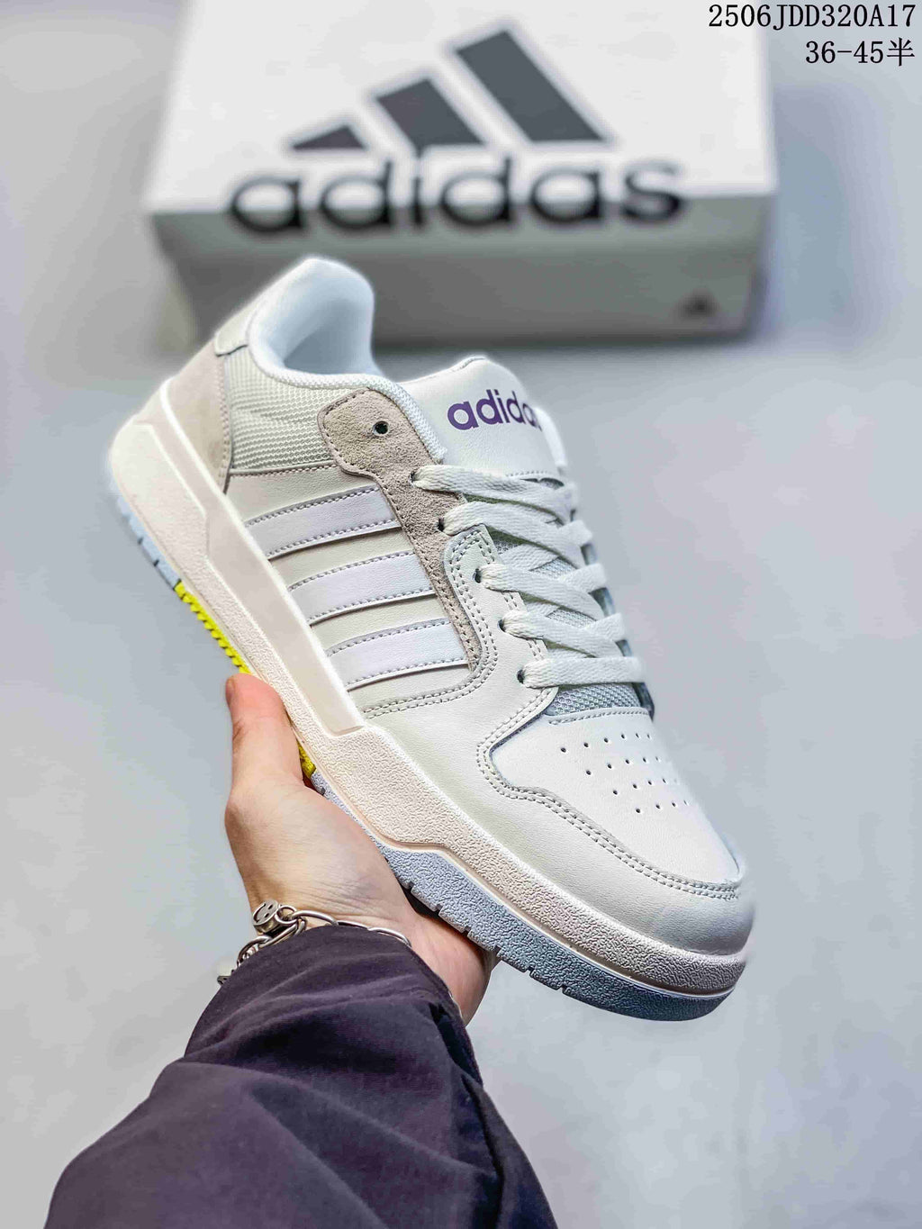 White adidas Entrap sneaker with pale neutral side stripes and a light-colored outsole.