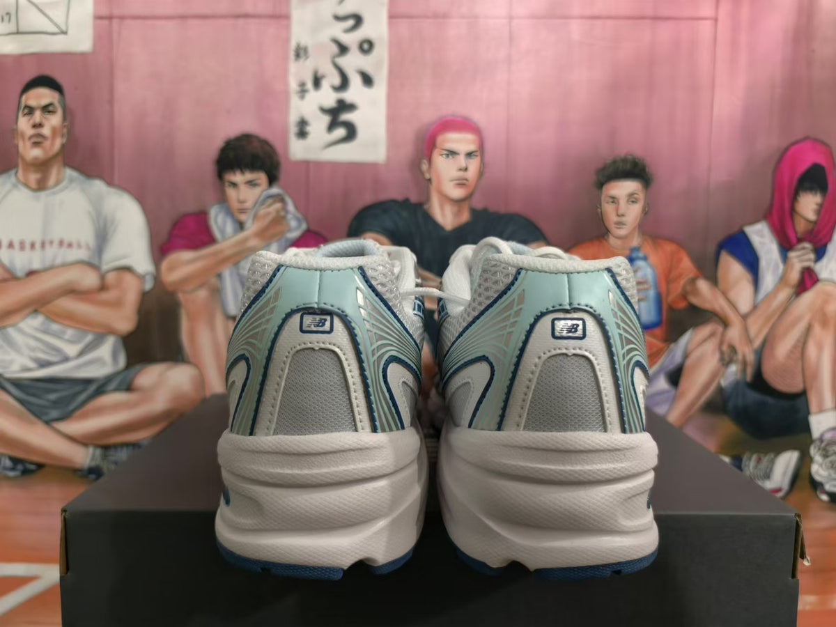 Rear view of white and blue New Balance sneakers