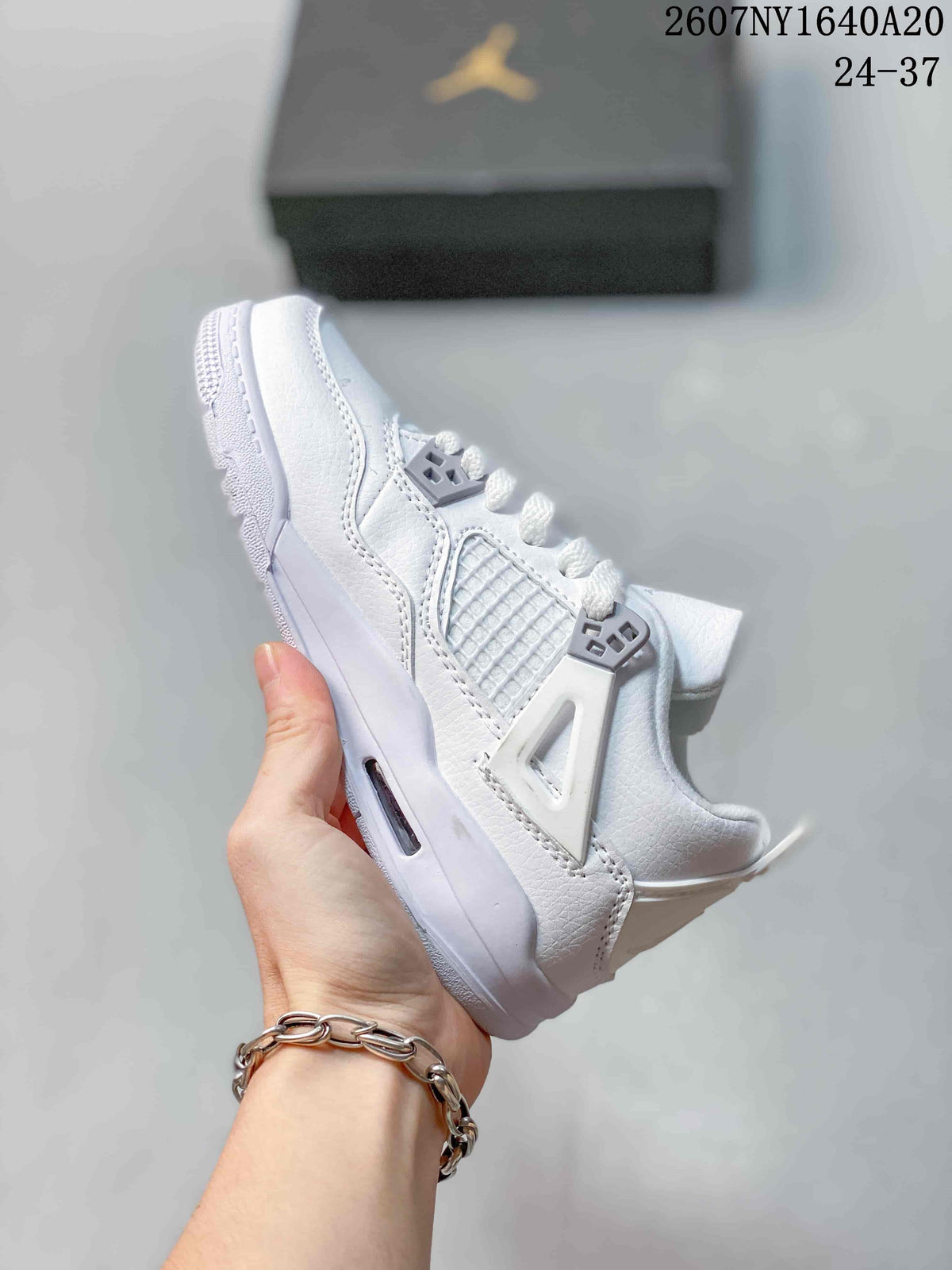 Side view highlighting the synthetic leather-style upper, mesh-style side panel, cage detail, and visible midsole window.